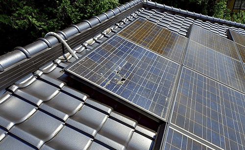 交換前：表面に穴の開いた破損した太陽光パネル